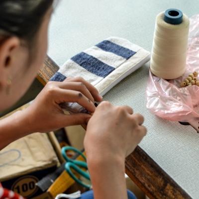 Projects Abroad Business Intern is hand making a product for a local shop during her Business Internship in Vietnam. Female Business Intern is handmaking a product with woven wool for a company during a Work Placement in Vietnam.